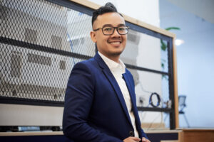 A Confident Man In Glasses Wearing A Business Suit