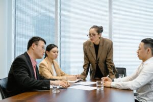 A Female Supervisor Leading A Meeting In An Office Setting